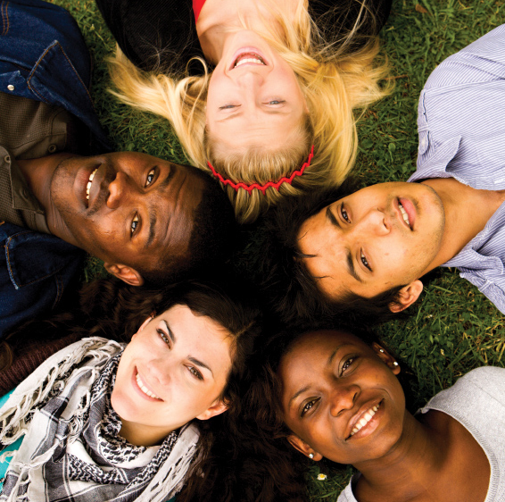 group of five teens laying down looking up at the camera